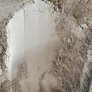 Close-up of raw white lumps and powder of BT-384 organic bentonite and organoclay rheology modifier.